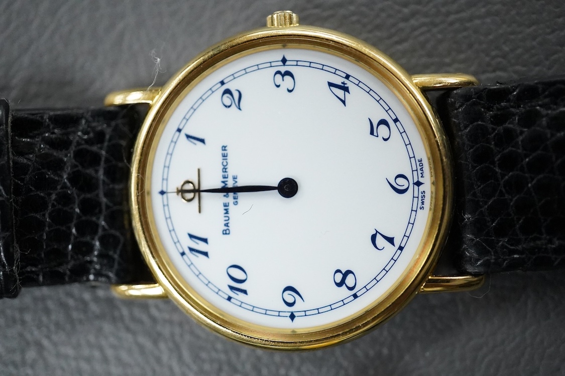 A lady's 18k Baume & Mercier quartz dress wrist watch, with Arabic dial, case diameter 27mm, the case back numbered 15602 1877944, on a Baume & Mercier black leather strap, together with a base metal Ralco manual wind wr